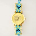 Goldene Uhr mit blauem Stoffarmband und Elefant im Ziffernblatt